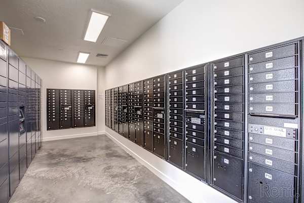 A row of black mailboxes are lined up against a wall. at Paperbox Lofts Apartments, Salt Lake City  , Utah